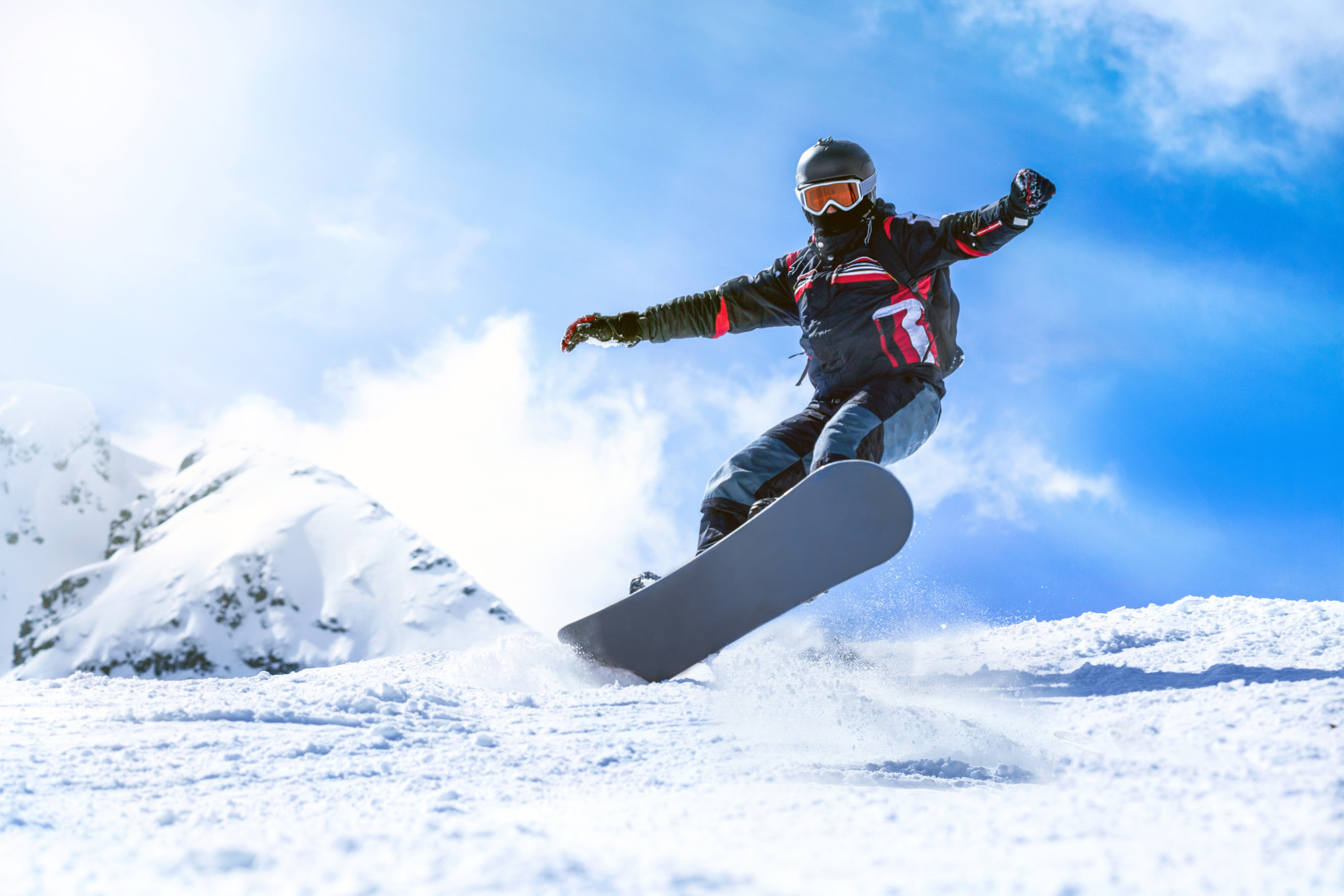 Jumping snowboarder from hill in winter Jumping snowboarder from hill in winter